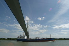 Ship crossing under bridge